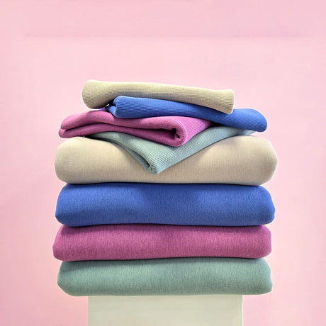 stack of multi colour fleece and bamboo fabrics with matching rib fabric