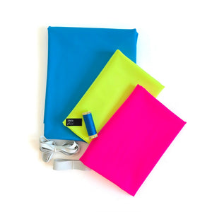 Three colorful fabric swatches (blue, neon yellow, hot pink) with a spool of thread on a white background.